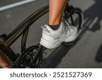 close up biker foot wearing athletic footwear, on the pedal, biking concept