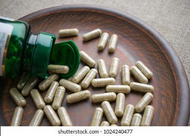 Close Up Biotin Capsules And Bottle On Clay Brown Plate On Burlap Background. Dietary Supplements For Healthy  Skin, Hair, Nail. Vitamins And Minerals For Vegans And Vegetarians. Superfood