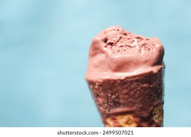 close up of bitten ice cream on blue background - Powered by Shutterstock