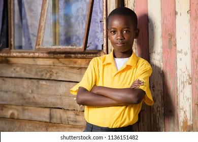 Close Up Of A Black Boy With His Arms Crossed While He Is Looking Straight Into The Camera