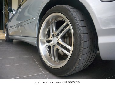 Close up of a black car tyre park at home. Sliver car with tyre                               