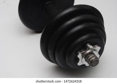 Close Up Black Dumb Bell Over White Background. Dumb Bell Is An Equipment Of Build Up Muscle.