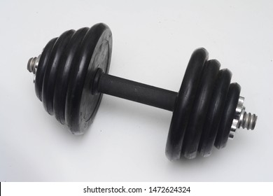 Close Up Black Dumb Bell Over White Background. Dumb Bell Is An Equipment Of Build Up Muscle.