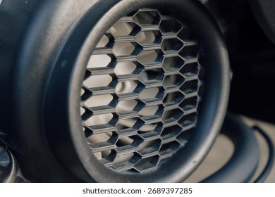 Close Up Of A Black Hexagonal Ventilation Grille On A Dark Mechanical Object 