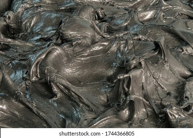 Close Up Of Black Industrial Grease.
Rich And Thick Texture Of Industrial Grade Grease Used To Smooth Out All Metal Friction