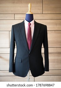 Close up of black jacket suit detail with pink shirt and red tie