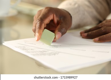 Close Up Of Black Man Hands Erasing Drawing With Rubber On A Desk At Home