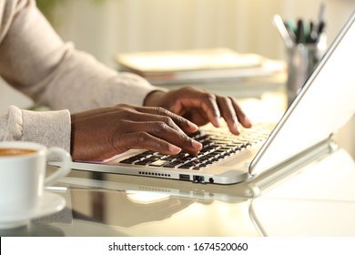 Close Up Of Black Man Hands Typing On A Laptop On A Desk At Home