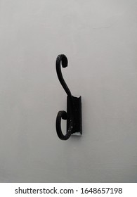 Close Up Of Black Metallic Vintage Coat Hook On The Wall.