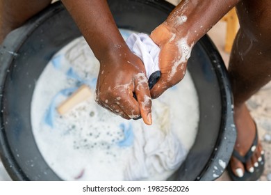 Close Up Of A Black Person Hand Washing Clothes In A Basin - Concept On People Doing Laundry