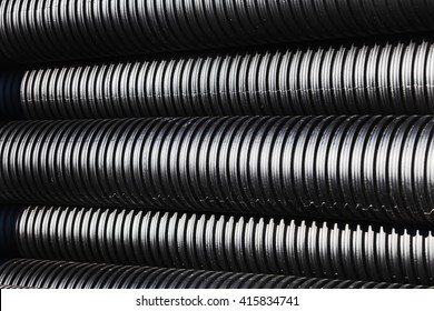 Close up of black plastic pipes for water with diminishing perspective