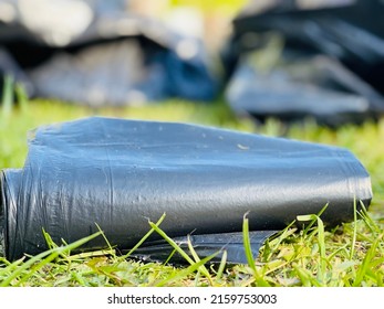 Close Up Of A Black Plastic Polyethylene Trash Bag Roll.