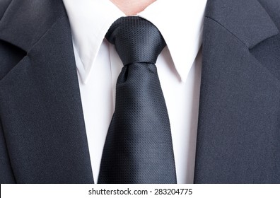 Close Up With Black Suit And Tie And White Shirt