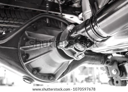 Close up of the black and white  pickup truck drive shaft