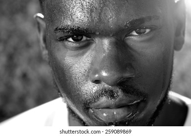 Close Up Black And White Portrait Of A Young Man Sweating With Intense Look Of Face