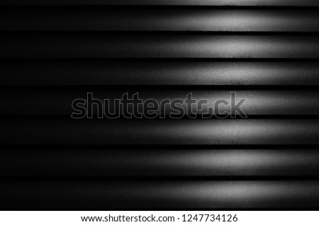 Close up Black window blinds with light, Dark background