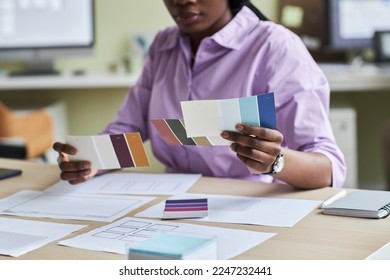 Close up of black young woman as creative designer holding color swatches in office, copy space - Powered by Shutterstock