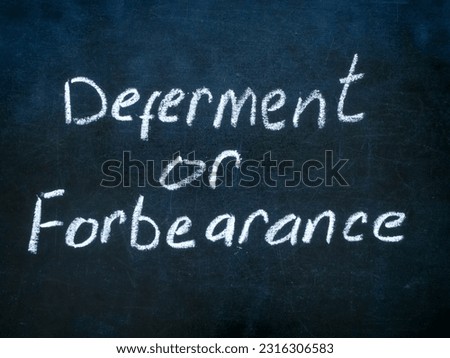Close up of blackboard with inscription deferment or forbearance.