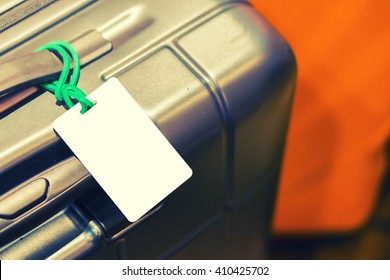 Close Up Of Blank Luggage Tag Label On Suitcase Or Bag With TRAVEL INSURANCE ,Can Be Used For Montage Or Display Your Products,selective Focus,vintage Color