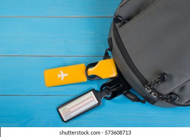 Close Up Of Blank Luggage Tag Label On Suitcase Or Bag With Travel Insurance. Travel Insurance Label Tied To A Backpack.