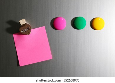 Close Up Of Blank Note On Refrigerator Door With Wooden Clip Heart Shape.
Colorful Magnet Stick On Fridge.