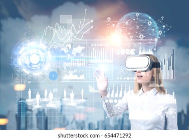 Close up of a blond businesswoman in vr glasses in city interacting with graphs in the sky. Toned image, Elements of this image furnished by NASA - Powered by Shutterstock