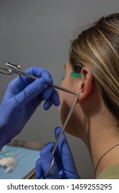 Close Up Of A Blonde Girl Getting Her Ear Pierced 