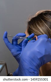 Close Up Of A Blonde Girl Getting Her Ear Pierced 