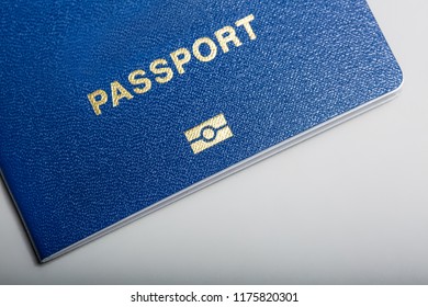 Close - Up Of Blue Biometric Passport With Identification Chip On White Background