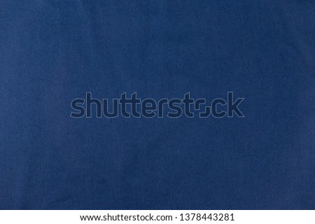 Close up of blue cloth abstract background with wrinkled texture or soft waves  for wallpaper.
