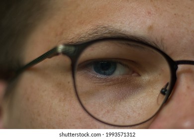 Close Up Of A Blue Eye Behind High Brow Glasses