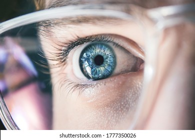 Close up of blue human eye with glasses. Reflection in glasses. Ophthalmology concept. Man with Glasses. Beautiful eye. - Powered by Shutterstock