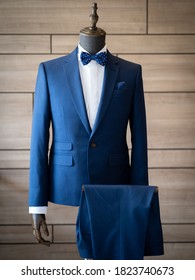 Close up of blue jacket suit with white tuxedo shirt , blue bow and blue handkerchief