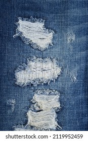 Close up blue Jean texture with a hole and threads
				
				