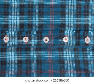 Close Up Of Blue Plaid Flannel Shirt With White Buttons