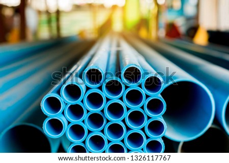 Close up to blue plastic pipe background, PVC pipes stacked in warehouse,  PVC water pipes used for construction