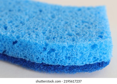 Close Up Of A Blue Sponge Isolated Against White Background.