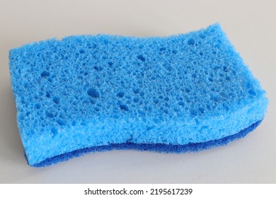 Close Up Of A Blue Sponge Isolated Against White Background.