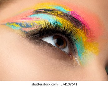 Close Up Of Blue Woman Eye With Beautiful Brown With Red And Orange Shades Smokey Eyes Makeup. Modern Fashion Make Up.