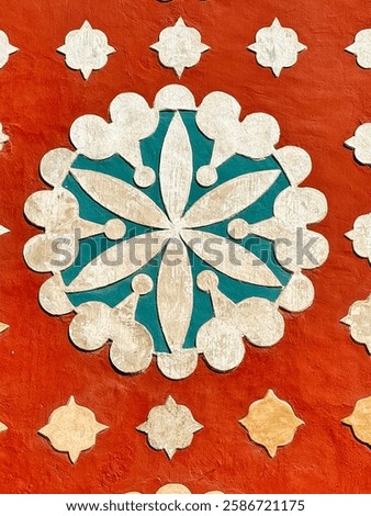 Close up of the Blue-and-white sgraffito rosette, blend of Mayan and Christian motifs on the red coloured walls of the Church of Santo Domingo de Guzman in Uayma Town,near Valladolid,Yucatan,Mexico
