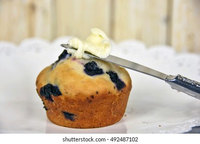 Close Up Of Blueberry Muffin With Butter On Knife