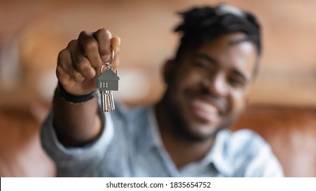 Close Up Blurred Background View Of Excited African American Male Renter Show New House Keys Buy First Home. Happy Biracial Man Tenant Excited With Moving Relocation. Real Estate, Realty Concept.