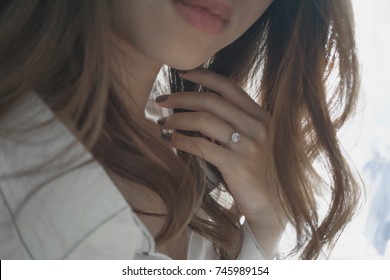 Close Up Of A Blurred Ring On Woman's Finger.Wedding And Love Concept.