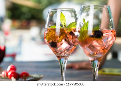 Close up blush rose wine glass with mulberry and ice. - Shutterstock ID 1199505388