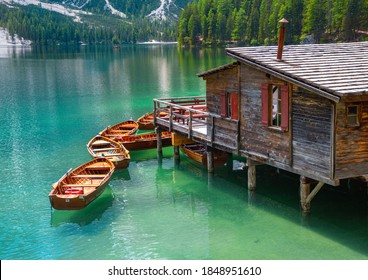 close up of boatshouse in the clear calm water of iconic mountain lake Pragser Wildsee (Lago di Braies) in Dolomites, Unesco World Heritage, South Tyrol, Italy