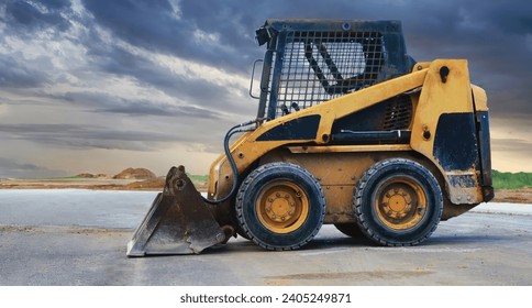a close up of a bobcat or a skid loader constructing housing blocks