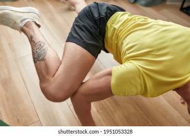 Close Up Of Body Of Athletic Strong Man Having Training At Home, Standing On His Arms And Legs In The Air. Hard Yoga Pose. Fitness, Healthy Lifestyle, Stay Home Concept