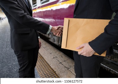 Close Up Body Part Of Two Business Man Shaking Hands In The Train Station With Classic Old Train As Background. Mission Or Job Are Completed. Business, Negotiation, Travel And Agreement Concept.