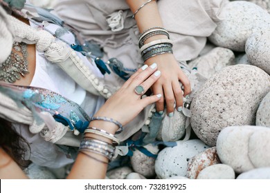 close up of boho styled woman hands with silver jewelry