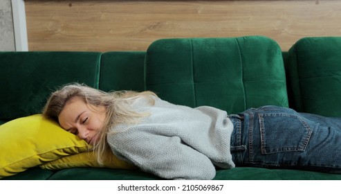 Close Up Bored Young Sleepy Woman Falls Down On Sofa. Apathetic Tired Lazy Lady Sleeping On Couch At Home.